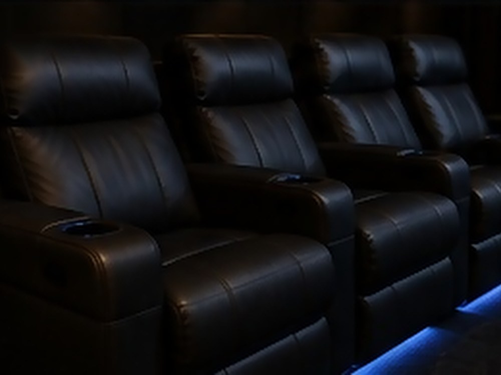 Electric recliners with integrated cup holders and floor lighting.